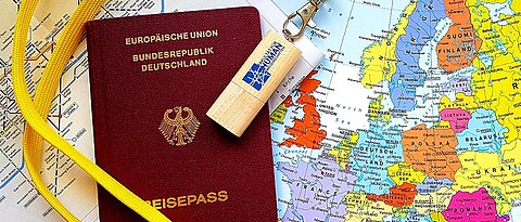 Map of the world, passport and USB stick (photo: Faculty of Human Sciences)