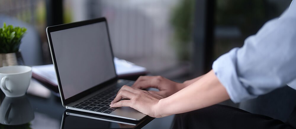 Asian businesswomen typing business information on keyboard laptop to working about planning of marketing business report while analyze investment and market stock of new startup in outside workplace.