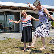 Besucherinnen des Gesundheitstags versuchen sich im Slacklining.